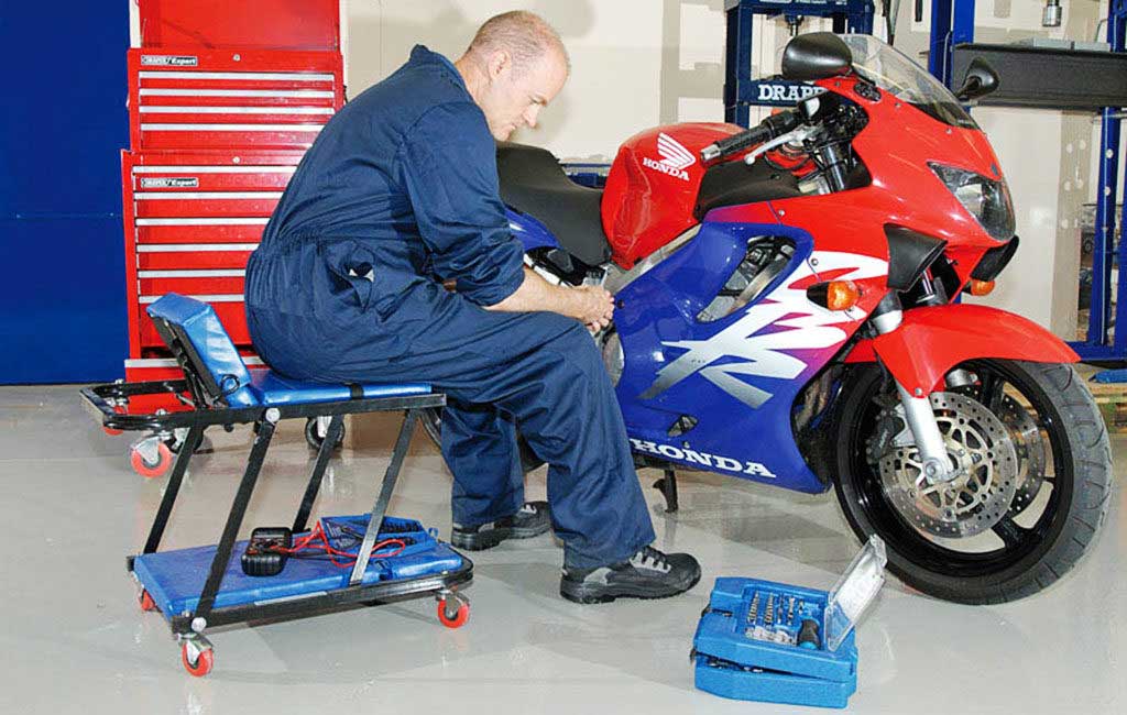 motorcycle creeper seat garage workshop 1024x650 - Basic Motorcycle Maintenance Checklist and Tools